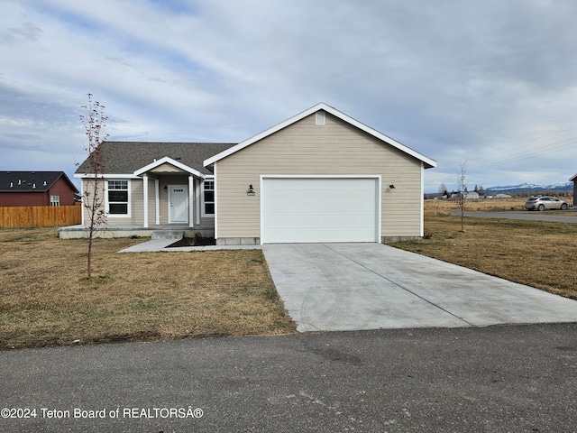 ranch-style home with a front lawn and a garage