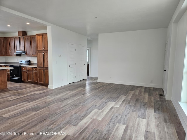 kitchen with black range with electric stovetop, exhaust hood, and light wood-type flooring