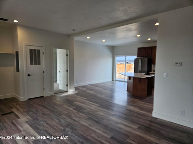 unfurnished living room featuring dark hardwood / wood-style flooring