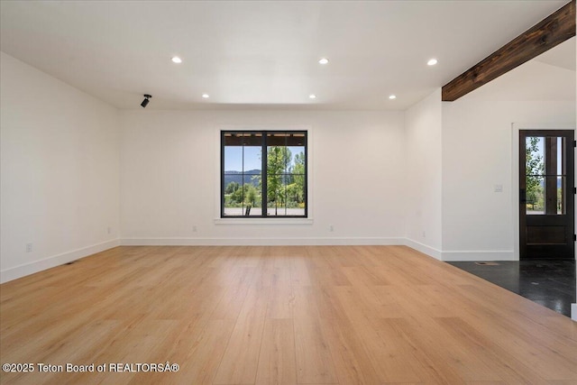 9071 Old Jackson Hwy, Victor, ID 83455 - empty room with healthy amount of natural light, recessed lighting, light wood finished floors, baseboards, and beam ceiling