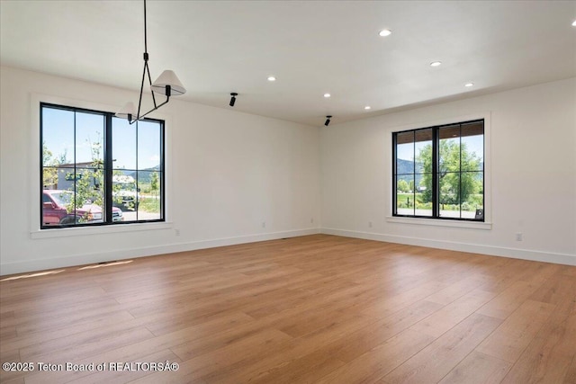9071 Old Jackson Hwy, Victor, ID 83455 - spare room featuring recessed lighting, light wood-style floors, baseboards, and a chandelier