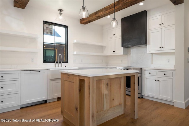 9071 Old Jackson Hwy, Victor, ID 83455 - kitchen with stainless steel stove, custom exhaust hood, open shelves, light wood finished floors, and beamed ceiling
