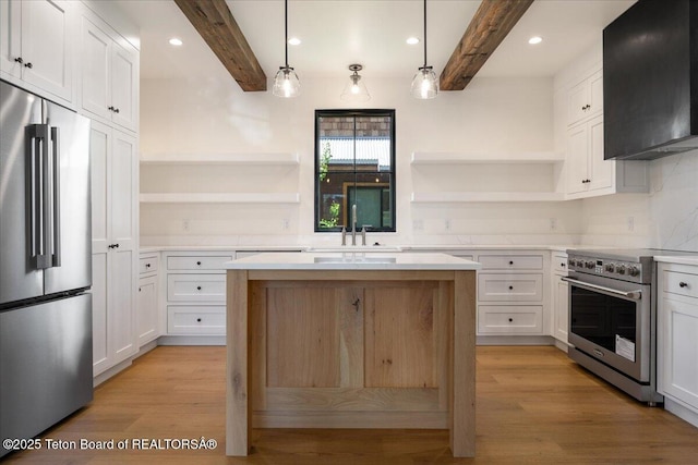 9071 Old Jackson Hwy, Victor, ID 83455 - kitchen featuring high end appliances, open shelves, a sink, beamed ceiling, and exhaust hood