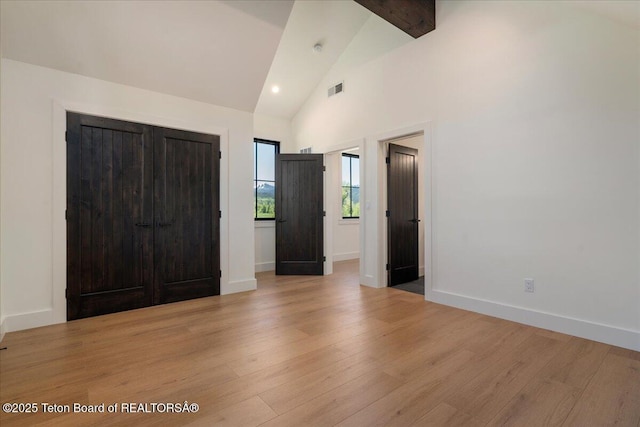 9071 Old Jackson Hwy, Victor, ID 83455 - unfurnished bedroom featuring light wood-type flooring, baseboards, beamed ceiling, and high vaulted ceiling