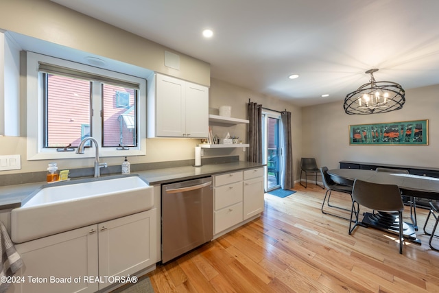 kitchen featuring white cabinetry, sink, dishwasher, hanging light fixtures, and light hardwood / wood-style floors