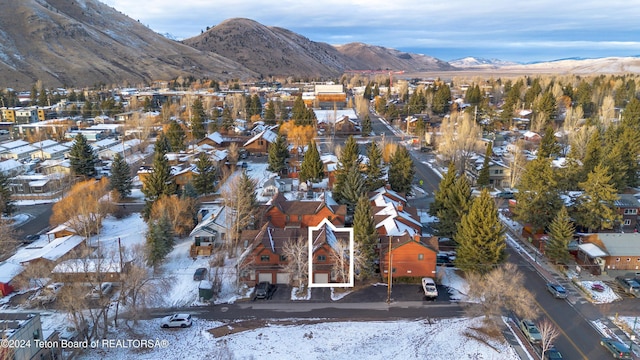 snowy aerial view with a mountain view