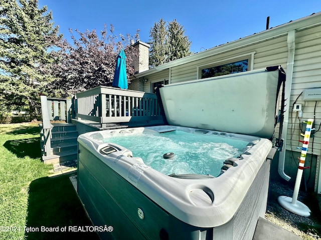 exterior space with a hot tub and a deck