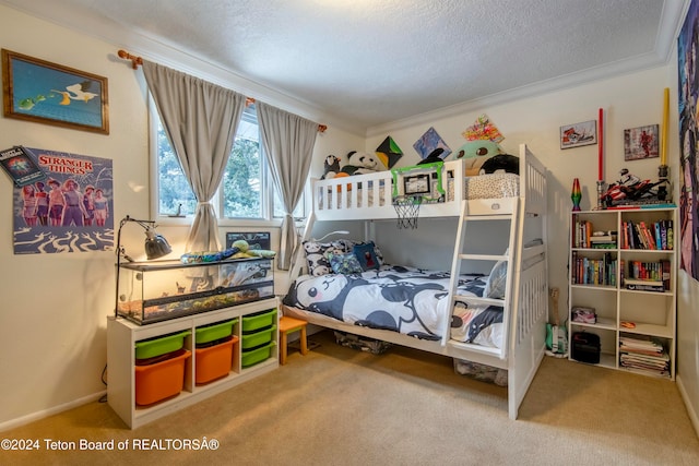 bedroom with carpet floors, a textured ceiling, and ornamental molding