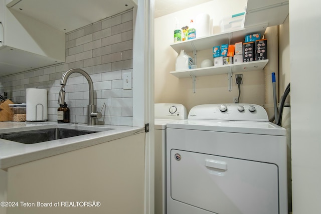 washroom with independent washer and dryer and sink