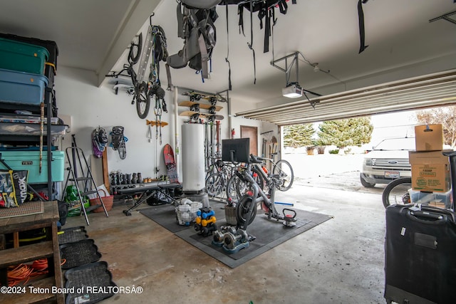 garage featuring gas water heater and a garage door opener