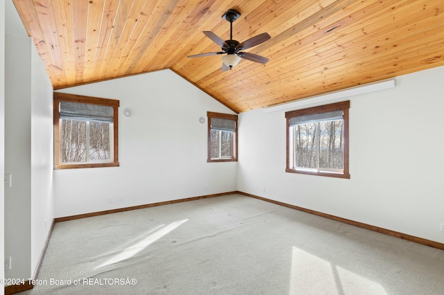 carpeted spare room featuring ceiling fan, wooden ceiling, and lofted ceiling