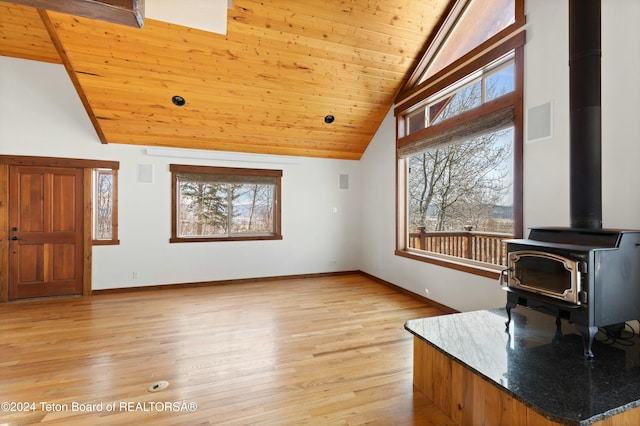 living room featuring wood ceiling, a wood stove, high vaulted ceiling, and light hardwood / wood-style floors