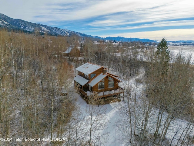 snowy aerial view with a mountain view