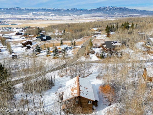 snowy aerial view featuring a mountain view