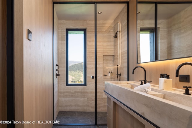 bathroom featuring a tile shower and vanity