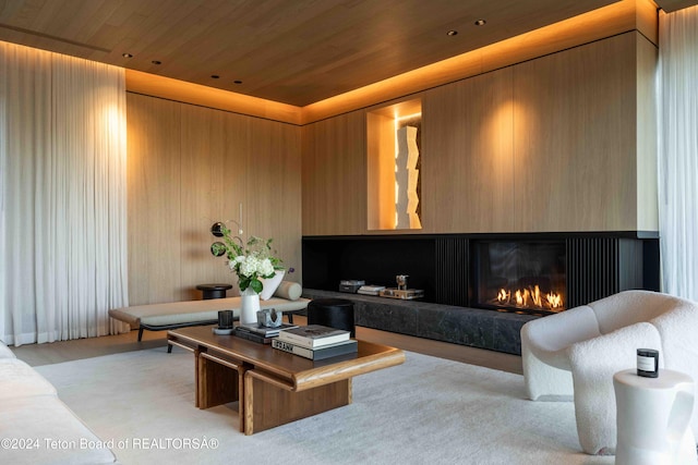 living room with wood ceiling and wood walls