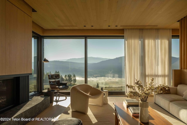 living room with wood ceiling and a mountain view