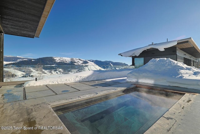 snow covered pool with a mountain view