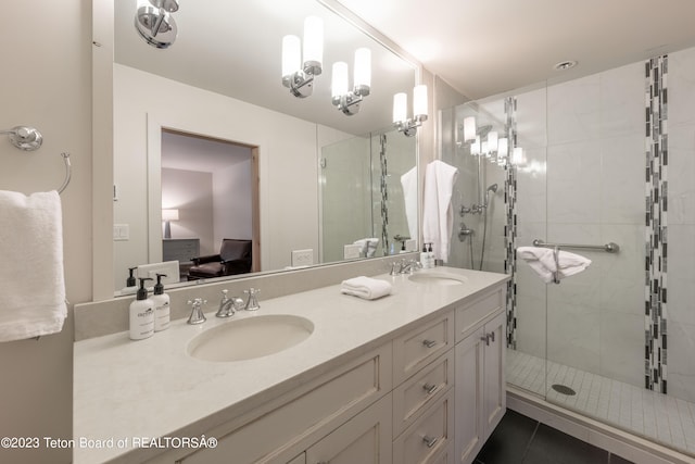 bathroom featuring tile patterned floors, vanity, and a shower with door