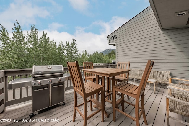 deck featuring a mountain view and grilling area