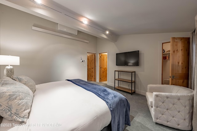 carpeted bedroom featuring vaulted ceiling, a spacious closet, a closet, and an AC wall unit