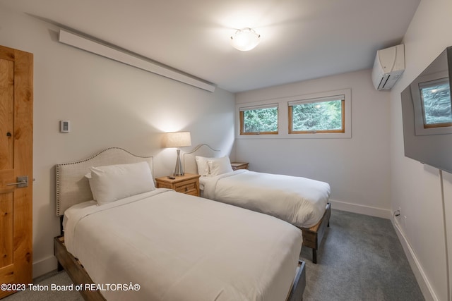 bedroom with an AC wall unit and dark colored carpet