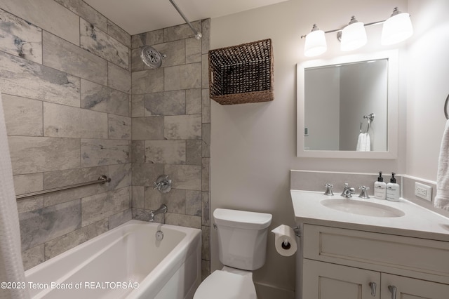 full bathroom with vanity, tiled shower / bath combo, and toilet