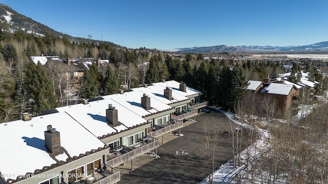 snowy aerial view with a mountain view