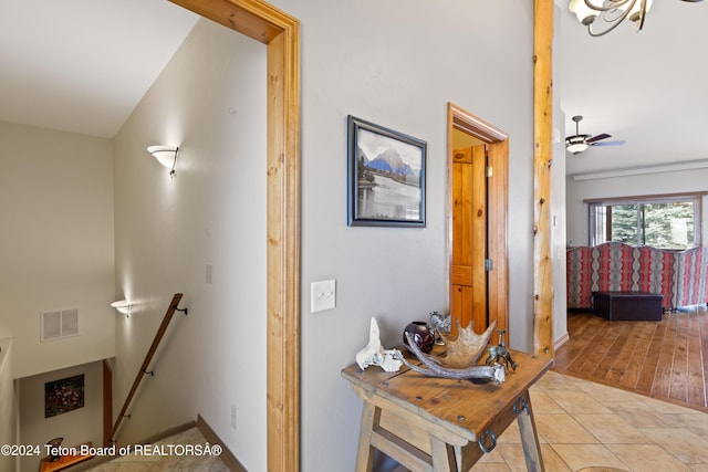 hallway featuring lofted ceiling and light hardwood / wood-style flooring