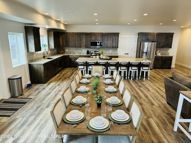 kitchen featuring a center island, sink, stainless steel appliances, and light hardwood / wood-style flooring