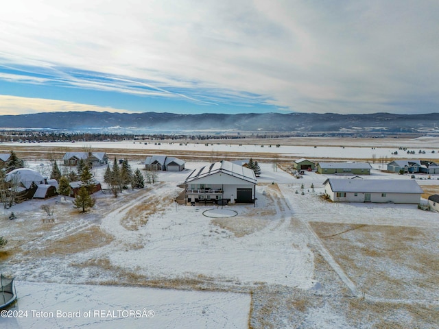 snowy aerial view with a mountain view