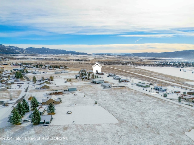 snowy aerial view with a mountain view