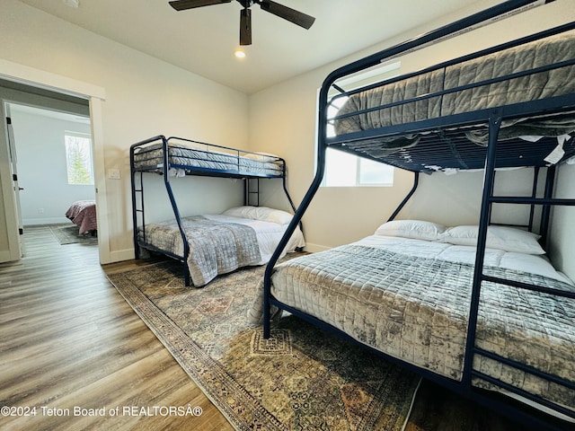 bedroom featuring hardwood / wood-style flooring, multiple windows, and ceiling fan