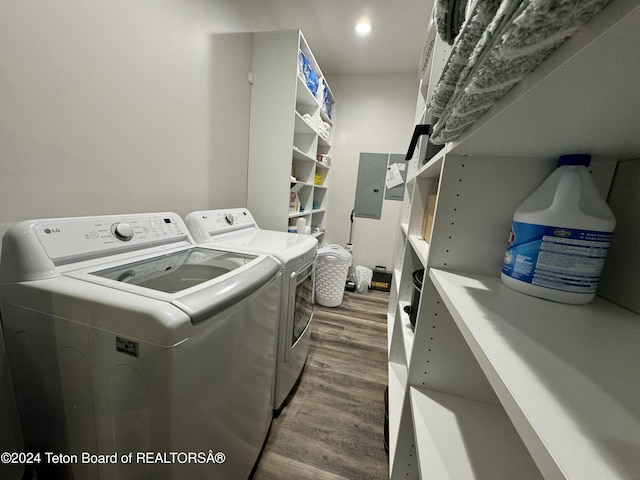 laundry area with washer and clothes dryer, wood-type flooring, and electric panel