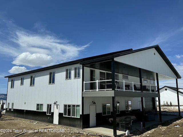 view of side of home featuring a patio area