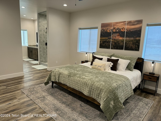 bedroom with connected bathroom and wood-type flooring