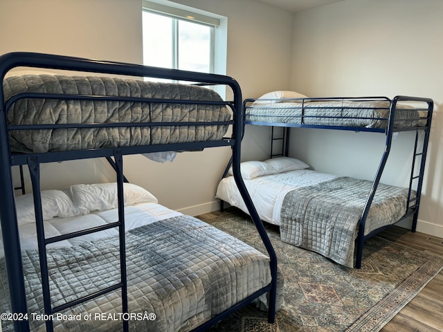 bedroom with dark hardwood / wood-style floors