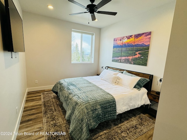 bedroom with ceiling fan and hardwood / wood-style floors