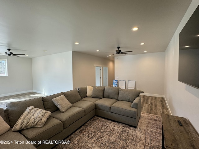 living room with ceiling fan and dark wood-type flooring