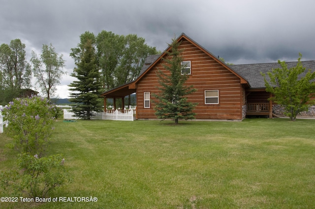 view of home's exterior with a yard