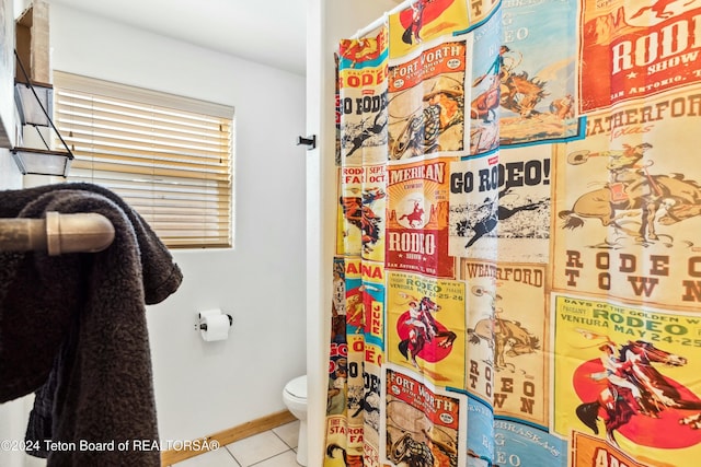 bathroom featuring tile patterned flooring and toilet