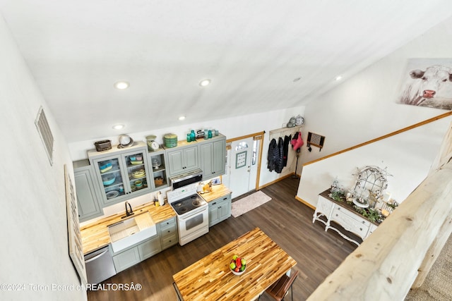 living room with dark hardwood / wood-style flooring, vaulted ceiling, and sink