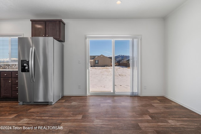 3829 Spruce Rd, Driggs, ID 83422 - kitchen with stainless steel refrigerator with ice dispenser, dark brown cabinets, dark wood-style floors, and crown molding