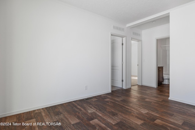 unfurnished room featuring a textured ceiling and dark wood-type flooring