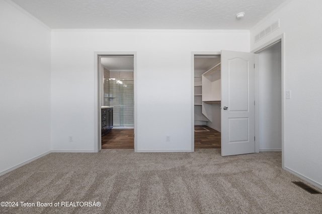 3829 Spruce Rd, Driggs, ID 83422 - unfurnished bedroom with carpet floors, ornamental molding, a walk in closet, a closet, and ensuite bath