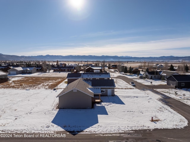 snowy aerial view with a mountain view