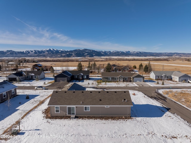 snowy aerial view featuring a mountain view