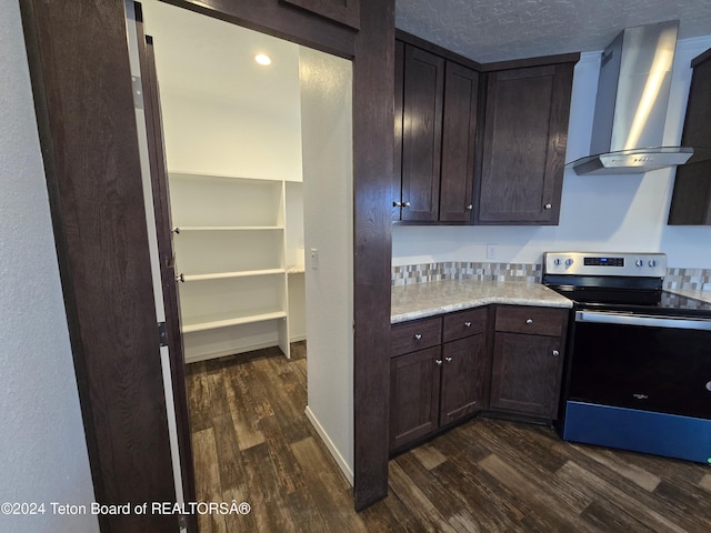 3829 Spruce Rd, Driggs, ID 83422 - kitchen with electric range, wall chimney exhaust hood, dark wood-type flooring, dark brown cabinetry, and a textured ceiling