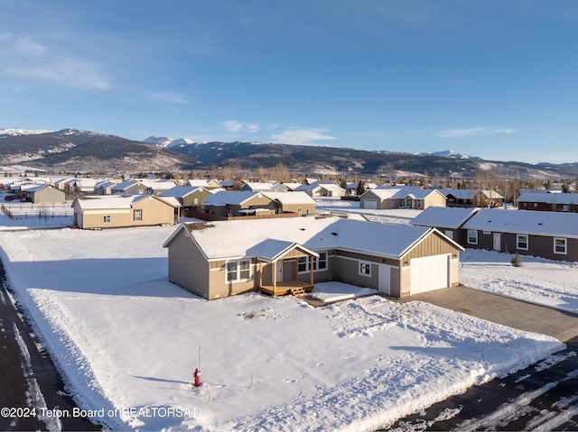 snowy aerial view featuring a mountain view