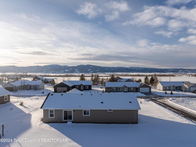 snowy aerial view with a mountain view